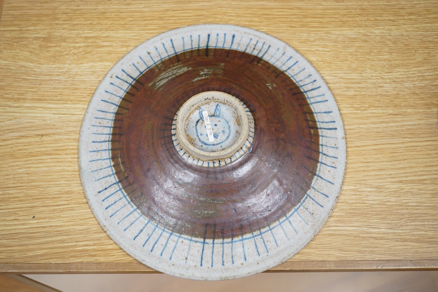 Eric James Mellon (1925-2014), a studio pottery dish, painted with a girl and cat, inscribed and dated 1971 to the foot rim, 29cm in diameter